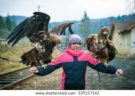 girl and an eagle, girl holding a large bird, girl with the eagles,  man and the falcon, birds of prey in the hands of a girl