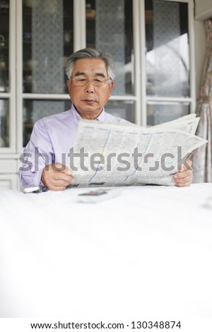 Oriental people read the newspaper