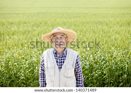 Senior man with hat in farmland