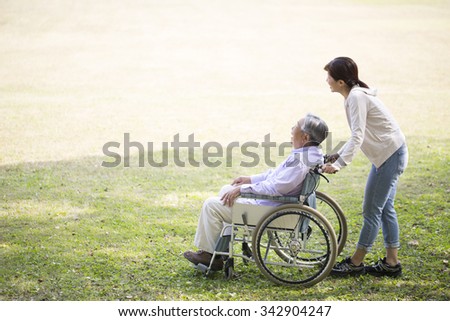 Wheelchair old man and a helper