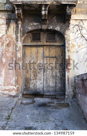 Old garage door with cracked driveway