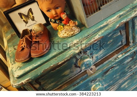 Cardiff,Wales,UK-February 27,2016:antique blue furniture,kids shoes and other vintage objects in an antiques store on 27 february 2016