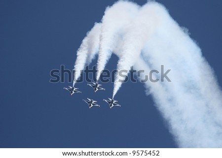 f-16 thunderbirds in dropping down with long smoke trails