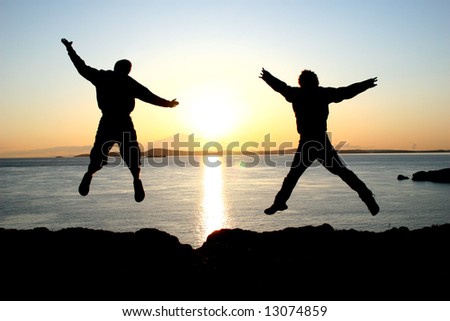 friends jumping against the sunset