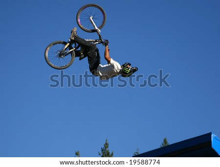 WHISTLER, BC - AUG 16, 2008: Giant Slopestyle Competition rider pulls a huge back-flip at Crankworx Festival