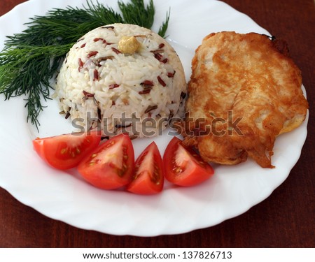 fried chicken fillet with rice and tomatoes