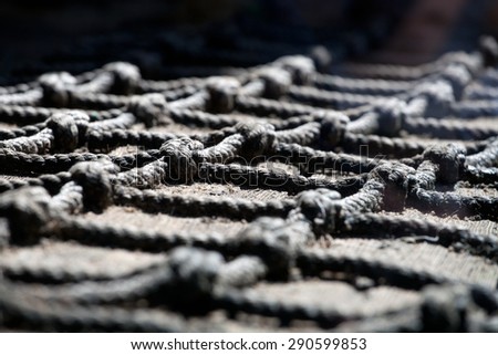 old fishing net lying over wooden surface