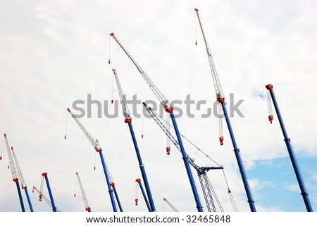 A lot of hydraulic cranes over sky