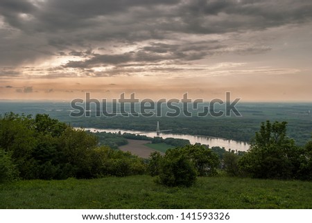 cloudy sky before sunset with bridge on the river