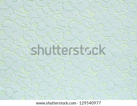 Light blue lace texture on a light green background