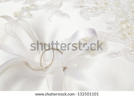 Wedding rings on a satin pillow