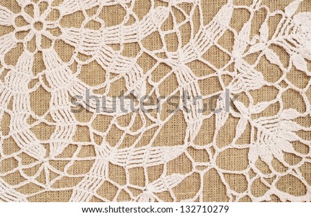 Canvas background with white crochet lace