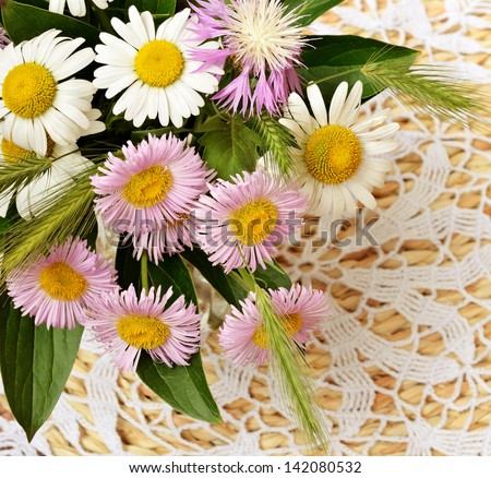 Bouquet of daisies on a lace background