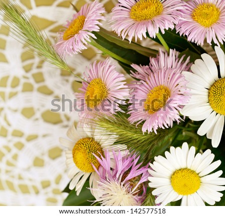 Summer wildflowers on white crochet background