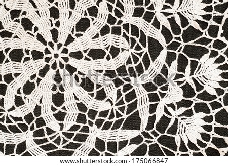 Background of white crochet lace on black