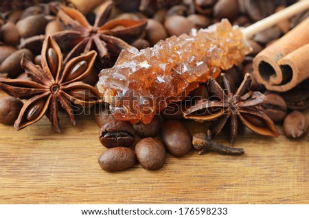 Fragrant spices coffee and brown sugar on a wooden background