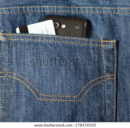 Mobile phone and credit card in a jeans pocket
