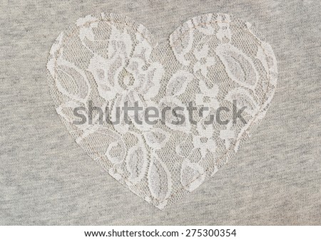 Gray jersey fabric with white lace heart for background