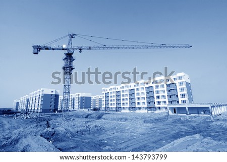 unfinished building and tower crane, at a construction site, north china