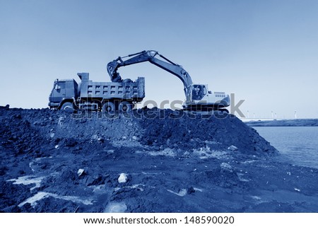 busy excavator at the construction site of water conservancy project