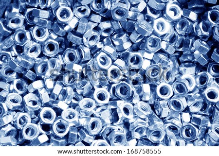 screw nut piled up together, closeup of photo