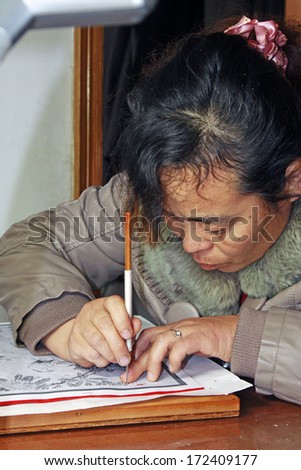 FUCHENG - DECEMBER 8: The female craftsmen used kedao production of paper cutting, on december 8, 2013, fucheng, hebei province, China.