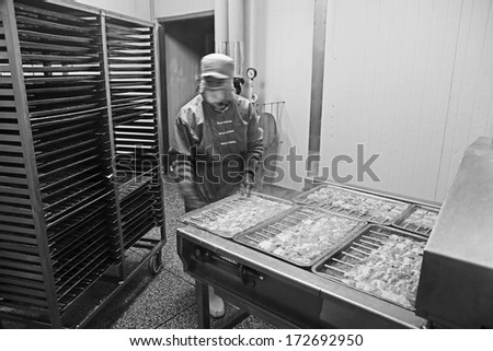 TANGSHAN - DECEMBER 20: Workers in a meat processing production line, in a food processing enterprise, on December 20, 2013, tangshan city, hebei province, China.