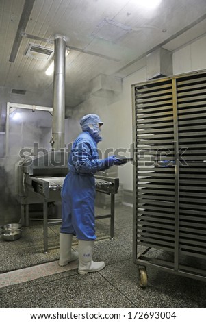 TANGSHAN - DECEMBER 20: Workers in a meat processing production line, in a food processing enterprise, on December 20, 2013, tangshan city, hebei province, China.