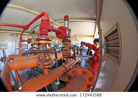 TANGSHAN, CHINA - DECEMBER 20: The worker in a compressed natural gas box and operation, in a manufacturing enterprise, on December 20, 2013, tangshan city, hebei province, China.