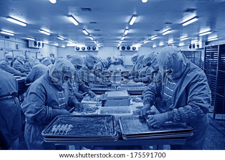 Workers in a meat processing production line, in a food processing enterprise, on December 20, 2013, tangshan city, hebei province, China.