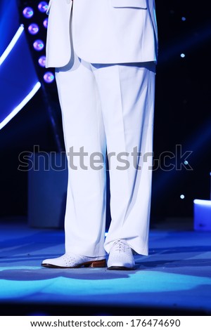 white shoes and white pants on the stage, closeup of photo