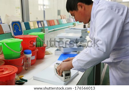TANGSHAN, CHINA - DECEMBER 22: Lab technicians were testing, in a solar equipment manufacturing enterprises on december 22, 2013, tangshan, china.