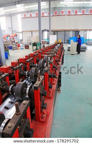TANGSHAN - DECEMBER 22: Transmission device on the production line, in a solar equipment production workshop on december 22, 2013, tangshan, china.