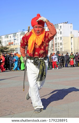 LUANNAN COUNTY, CHINA - FEBRUARY 9: Monkey King wearing colorful clothes, performing yangko dance in the street, during the Chinese Lunar New Year, February 9, 2014, Luannan County, Hebei Province, China.