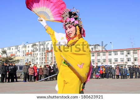 LUANNAN COUNTY - FEBRUARY 9: People wearing colorful clothes, performing yangko dance in the street, during the Chinese Lunar New Year, February 9, 2014, Luannan County, Hebei Province, China.