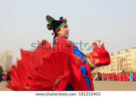 LUANNAN COUNTY - FEBRUARY 12: People wearing colorful clothes, performing yangko dance in the street, during the Chinese Lunar New Year, February 12, 2014, Luannan County, Hebei Province, China.
