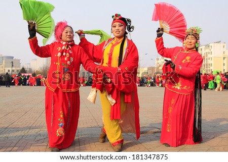 LUANNAN COUNTY - FEBRUARY 12: People wearing colorful clothes, performing yangko dance in the street, during the Chinese Lunar New Year, February 12, 2014, Luannan County, Hebei Province, China.