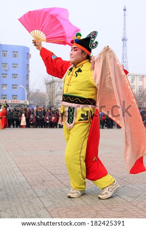 LUANNAN COUNTY - FEBRUARY 15: People wearing colorful clothes, performing yangko dance in the street, during the Chinese Lunar New Year, February 15, 2014, Luannan County, Hebei Province, China.
