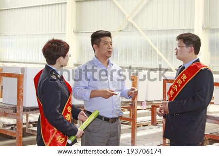 LUANNAN - MAY 4: Tax officials in the ceramic workshop visit, on May 4, 2014, Luannan county, hebei province, China.