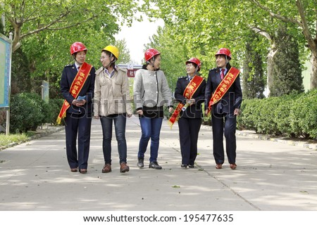 LUANNAN - MAY 4: Tax officials factory to carry out the campaign of the tax law, on May 4, 2014, Luannan county, hebei province, China.