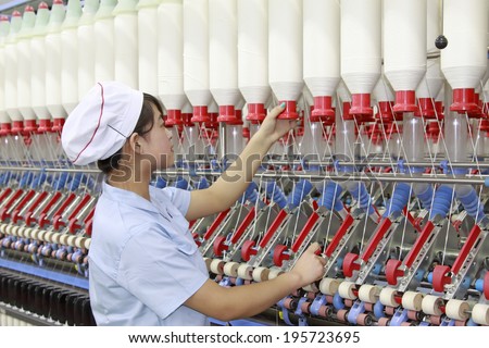 LUANNAN - MAY 4: Women were spinning production line operation in production workshop, on May 4, 2014, Luannan county, hebei province, China.