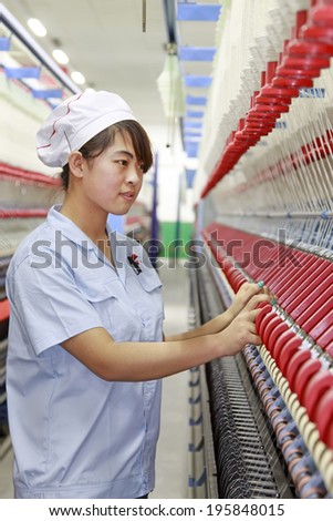 LUANNAN - MAY 4: Women were spinning production line operation in production workshop, on May 4, 2014, Luannan county, hebei province, China.
