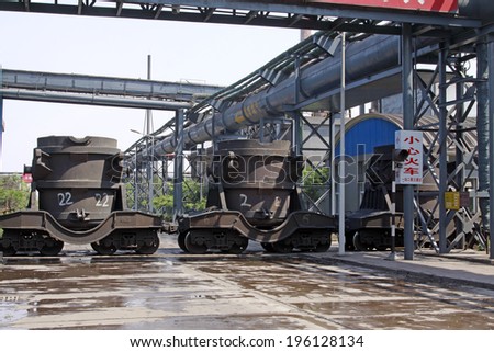 hot metal transport vehicles in a factory, closeup of photo