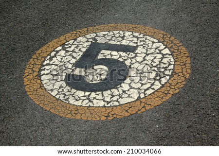 Numbers signs on the asphalt road, closeup of photo