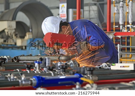LUANNAN COUNTY - AUGUST 16: Welders in production line in a factory, on august 16, 2014, Luannan County, Hebei Province, China