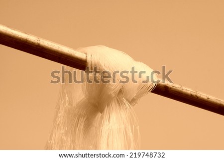 Nylon fishing nets hanging on iron rod, closeup of photo