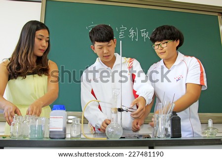 LUANNAN COUNTY - SEPTEMBER 3: Students doing chemical experiment in classroom, on september 3, 2014, Luannan County, Hebei Province, China