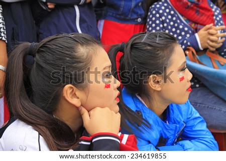 LUANNAN COUNTY - SEPTEMBER 27: Red national flag on the girl\'s face at the National Day party, on september 27, 2014, Luannan County, Hebei Province, China