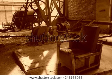 abandoned mechanical equipment and old sofa in a factory