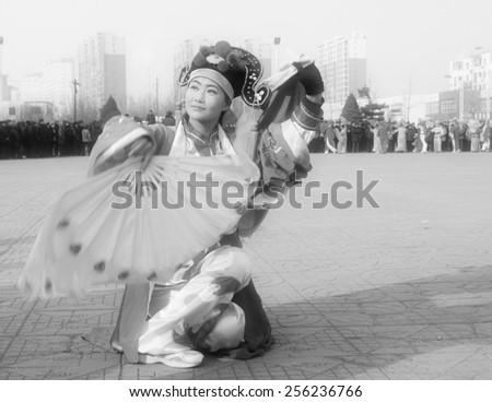 LUANNAN COUNTY - FEBRUARY 12: Young woman wearing colorful clothes, performing yangko dance in the street, during the Chinese Lunar New Year, February 12, 2014, Luannan County, Hebei Province, China.